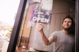 Business owner opening up his store.