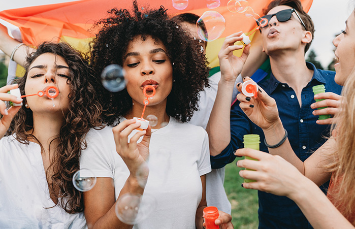 Young group blowing bubbles.
