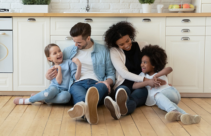 Family cuddling in the kitchen.