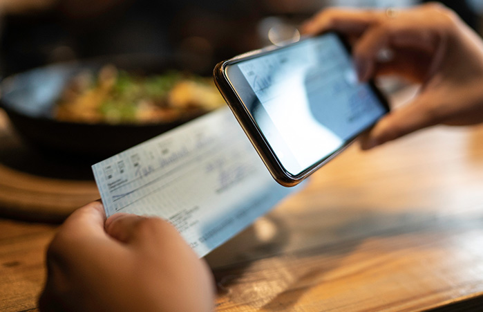 Person using phone to deposit a check.