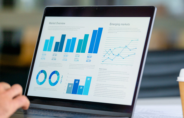Laptop with charts and graphs on the screen.