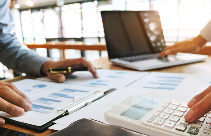 Business meeting with graphs and laptop.