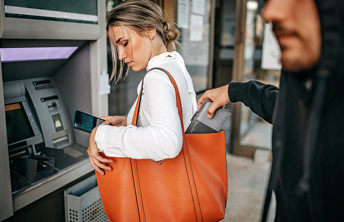 Thief stealing purse from woman.