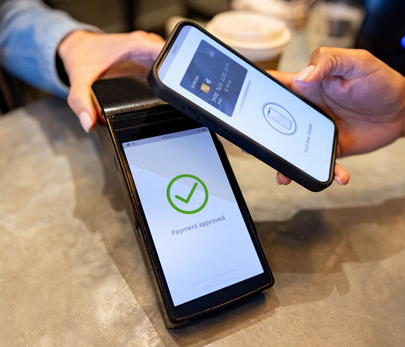 Person paying bill with mobile phone.