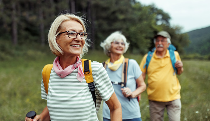 Retirees hiking outdoors.