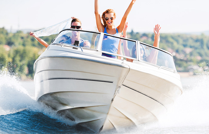 People riding in their boat on the lake.