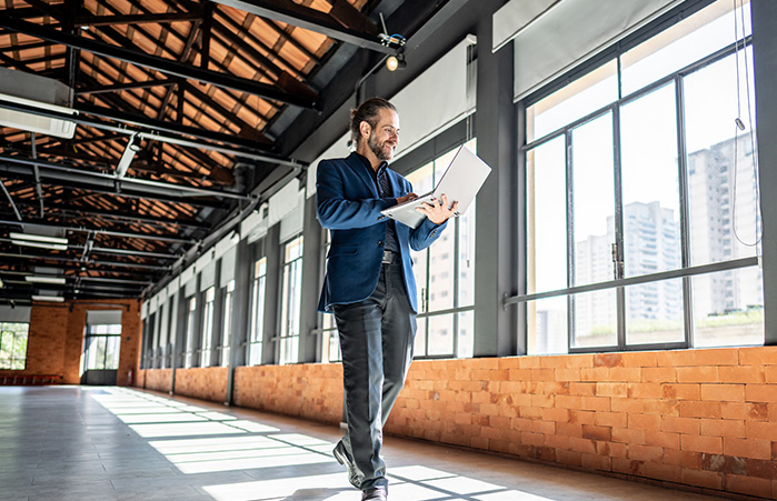 Person walking through an empty commercial building.