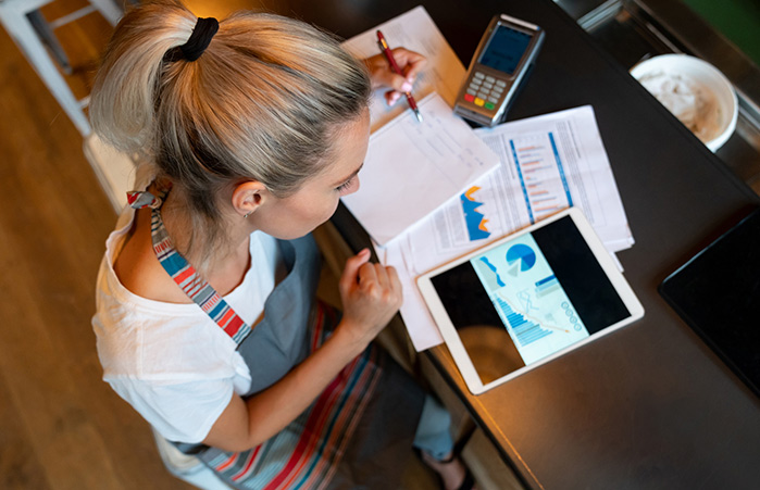 Business owner doing financials on the counter.