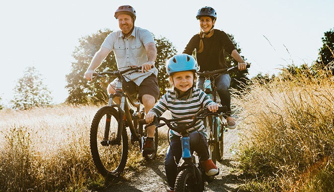 Family cycling on a trail.
