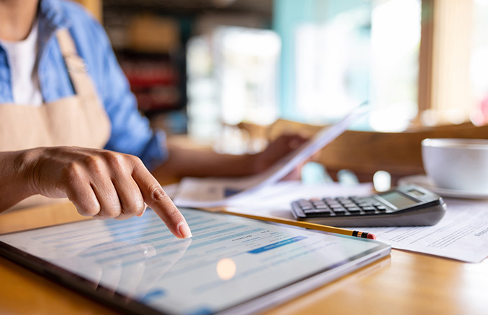 Person using tablet looking at financials.