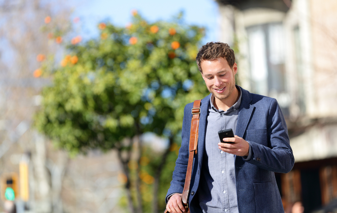 Man outdoors looking at cell phone
