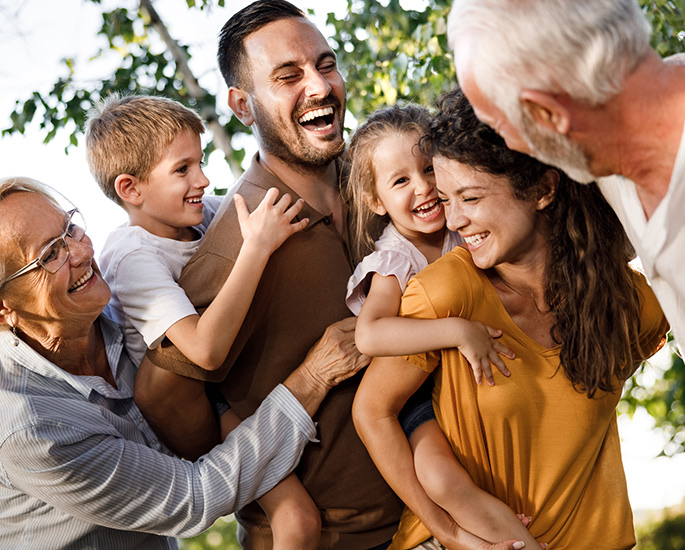 Parents, children, and grandparents smiling.